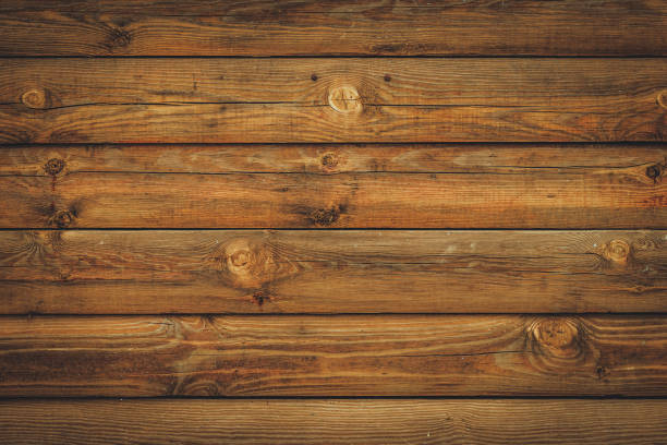 istock Brown wood background coming from natural tree. The wooden panel has a beautiful dark pattern, hardwood floor texture. Vintage rustic horizontal planks. 1403468539