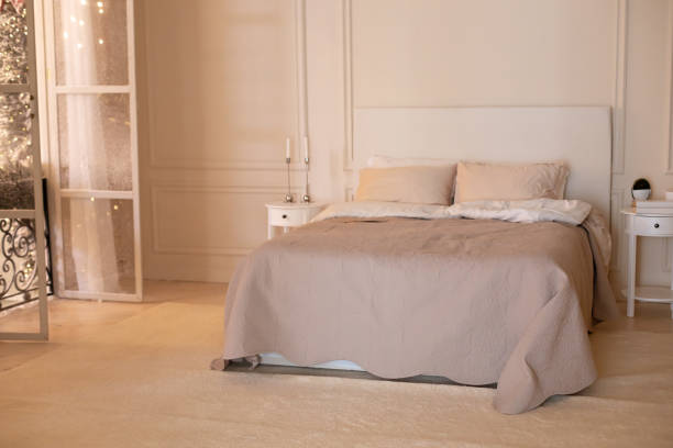 istock French balcony with wrought iron railings with open shutters and doors with curtain in scandinavian bedroom interior. Coffee table and Cozy bed with light linens and blanket. Concept of home comfort 1403468900