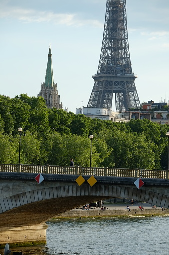 Paris, France, the 15th June 2022: the Seine river and the Invalides bridge with the spire of the American church and the Eiffel tower.