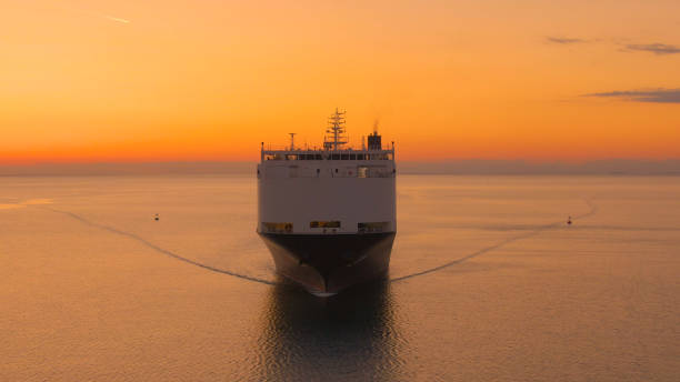 istock AERIAL: International cargo ship transporting merchandise on a sunny evening. 1403470161