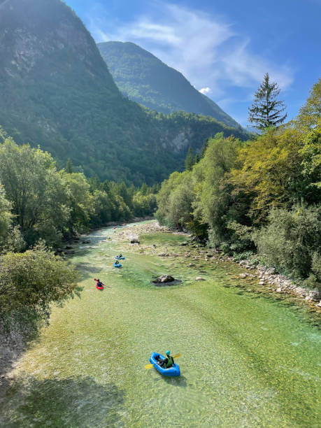 istock VERTICAL: Tourists paddle their kayaks down the lazy Soca river on a sunny day. 1403470567