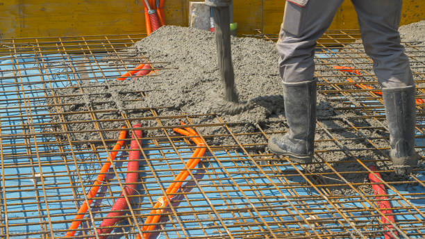 istock CLOSE UP: Contractors are pouring rough wet cement mixture while building house. 1403472081