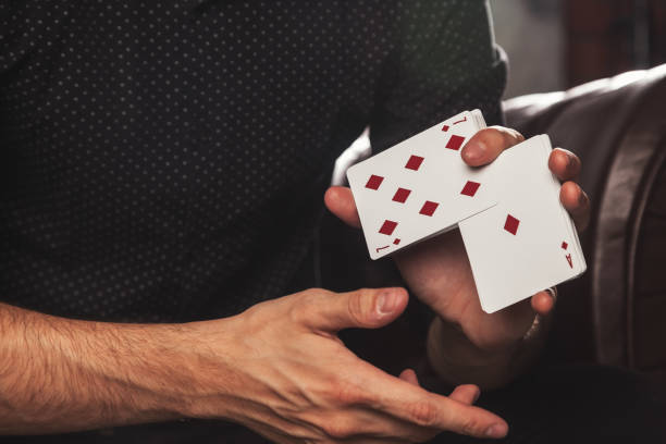 istock Close-up clever hands of magician with gambling cards 1403473288
