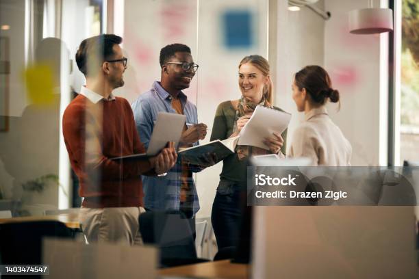 Young Startup Team Talking And Having Fun While Working At Creative Office Stock Photo - Download Image Now