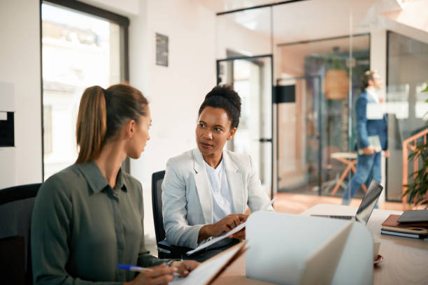 istock Two businesswomen cooperating while analyzing reports in the office. 1403475133
