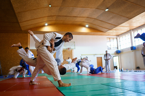 Two judo fighters stand their ground with fists ready to fight - cropped