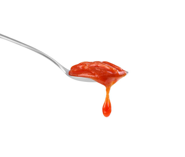 istock ketchup in a spoon on a white background 1403477972