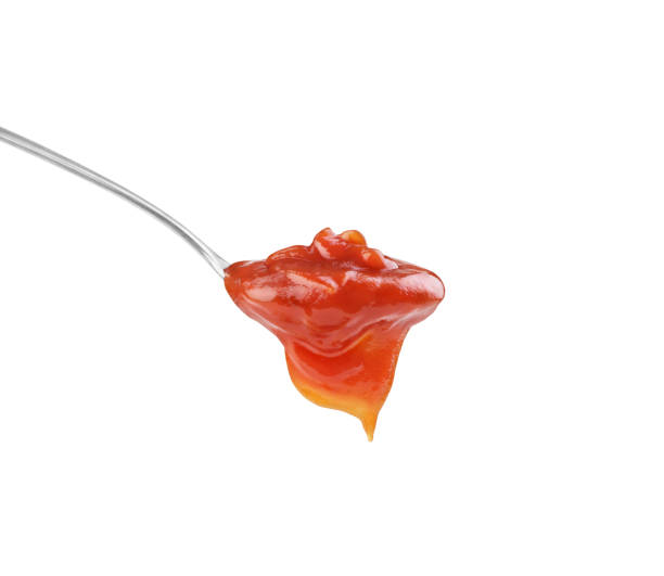 istock ketchup in a spoon on a white background 1403477973