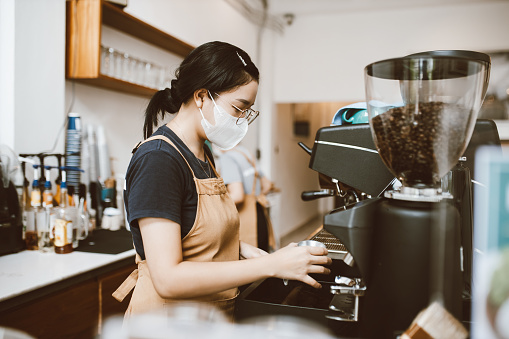 barista making coffee with professional machine, Coffee pouring into a cup, small business, startup business.