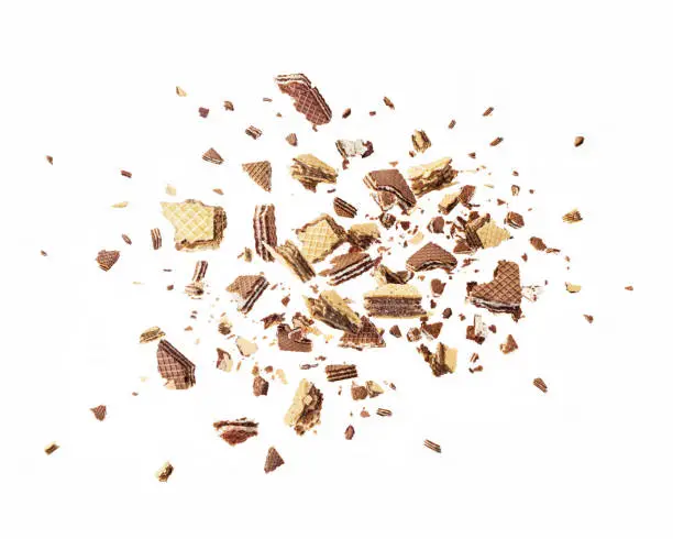 Wafers are explosive into pieces, with a chocolate splash isolated on a white background