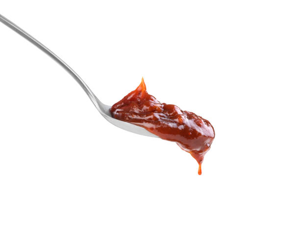istock dark sauce in a spoon on a white background 1403478297
