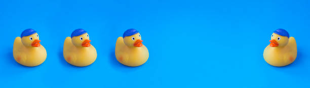 istock Banner. Yellow toy duckling for bathing on the blue background. Copy space. 1403478401