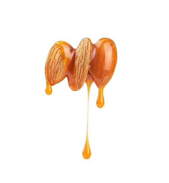 almonds sprinkled with caramel on a white background stock photo