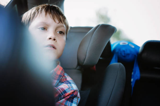 istock Sad bored caucasian boy travelling by car sitting by open window 1403479229