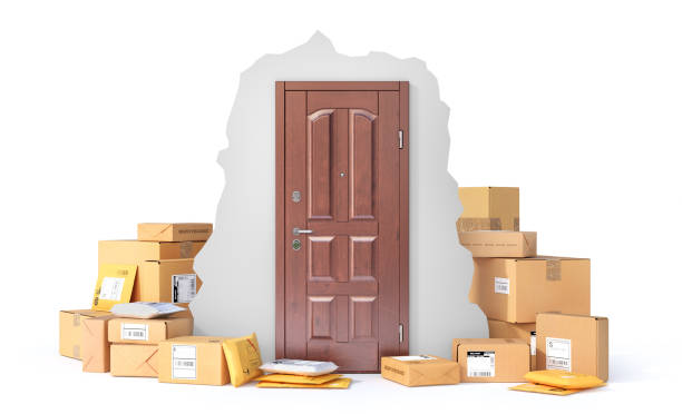 istock Delivery concept. Cardboard boxes and mail packages near door on a white background. 3d illustration 1403480381