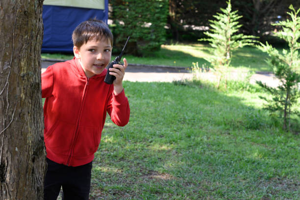 istock Child at a camp talking with a walkie talkie 1403481291