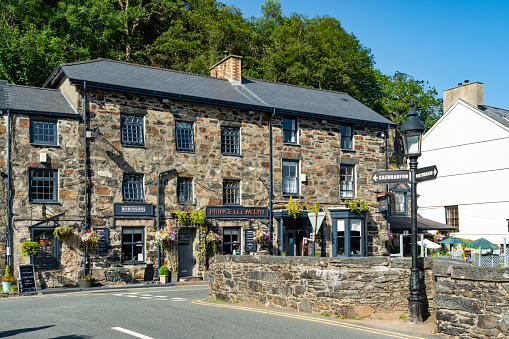Beddgelert, United Kingdom - July 16, 2021: The centre of the village in Snowdonia, north Wales showing local pubs and shops