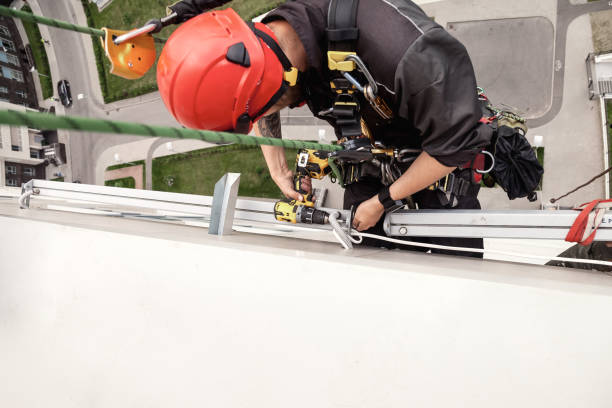 istock Industrial mountaineering worker hangs over residential facade 1403482862