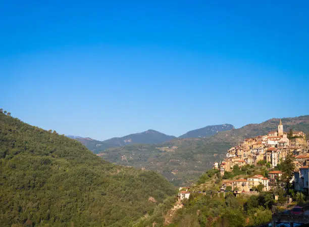 APRICALE, ITALY - CIRCA AUGUST 2020: traditional old village made of stones located in Italian Liguria region  with blue sky and copyspace