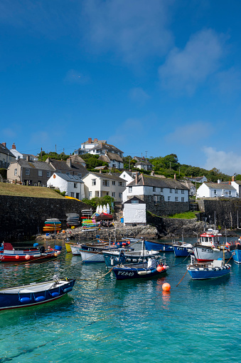 Coverack, United Kingdom - May 20, 2022: The harbour with moored boats in the picturesque Cornish seaside fishing village.