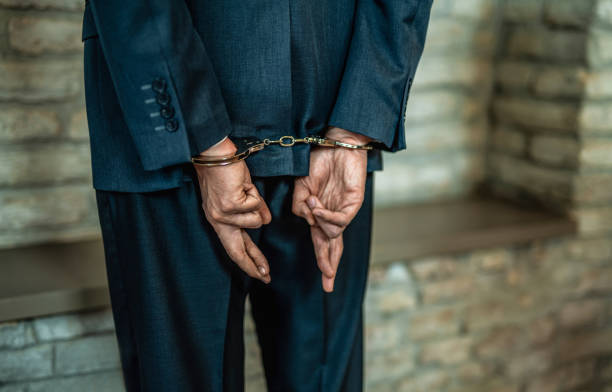 istock Handcuffed deceptive businessman getting arrested. 1403483580