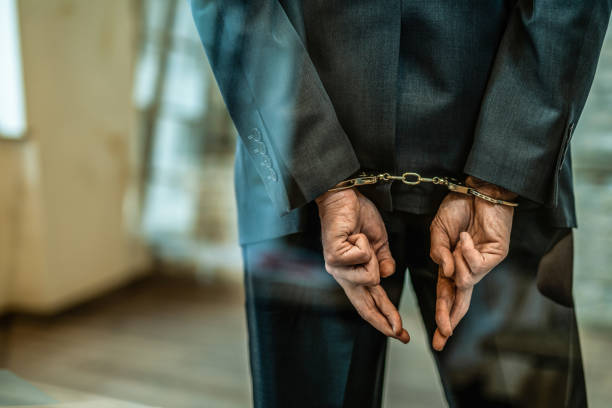 istock Handcuffed deceptive businessman getting arrested. 1403483650