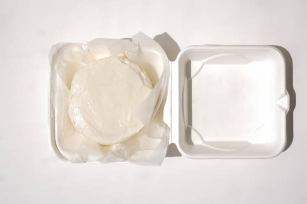 istock Beautiful white vegan cake with cream in eco-friendly delivery package 1403484487