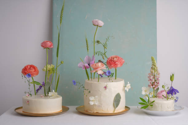 istock Three  white wedding cake with mixed fresh flowers 1403484717