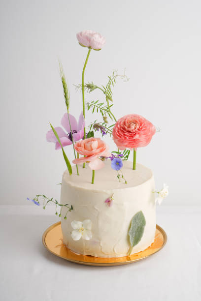 istock Wedding white cake with cream on a white background on a golden plate 1403484731