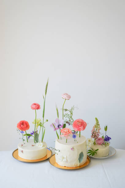 istock Three wedding white cakes with cream with delicate floral decor 1403484755
