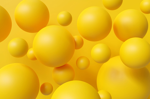 Different size yellow spheres on the yellow background, abstract composition with spheres