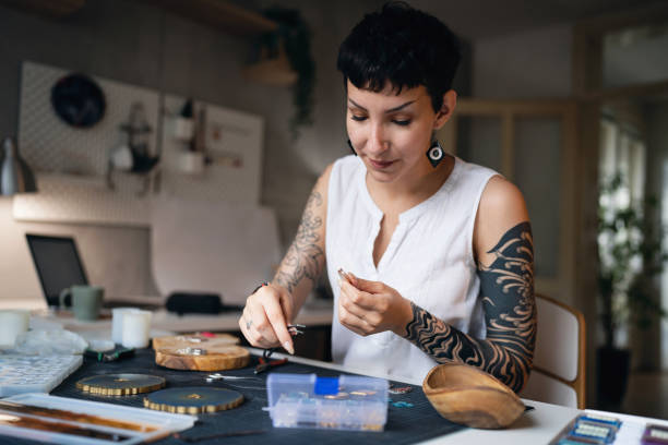 istock Caucasian craft woman making epoxy jewelry at her workshop 1403486231