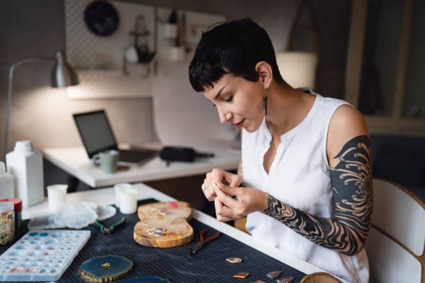 istock Caucasian craft woman making epoxy jewelry at her workshop 1403486268