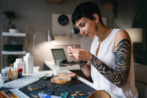 istock Caucasian craft woman making epoxy jewelry at her workshop 1403486344