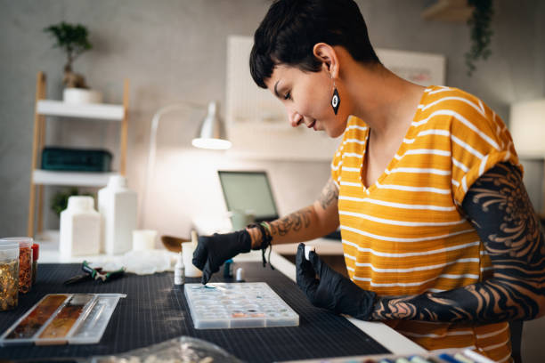 istock Craft woman pouring epoxy in the silicone mold, while working from her home workshop 1403487289