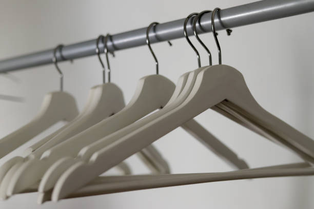 istock empty white wooden hangers hung on a rack 1403488873
