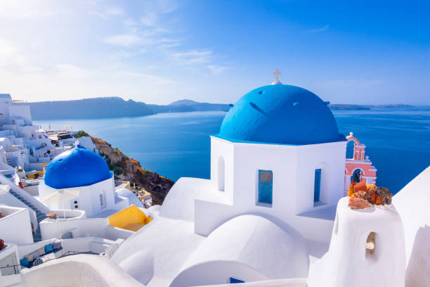 santorini island, greece. traditional and famous houses and churches with blue domes over the caldera, aegean sea - caldera imagens e fotografias de stock