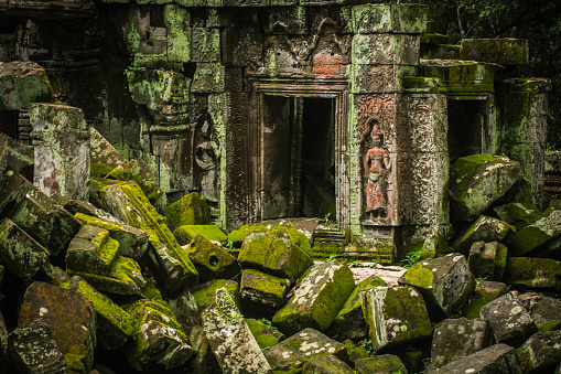 A pile of rocks with green mossy islands used to build Ta Prohm Temple in Angkor Thom, Siem Reap, Cambodia.