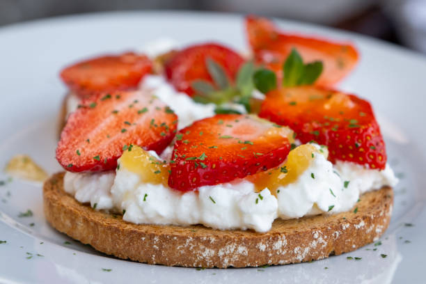 Healthy toast with strawberry, cottage cheese and honey. Tasty breakfast. Summer appetizer stock photo