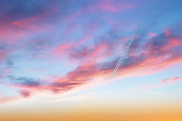 istock The plane flies across the sky among the dramatic clouds. 1403494951