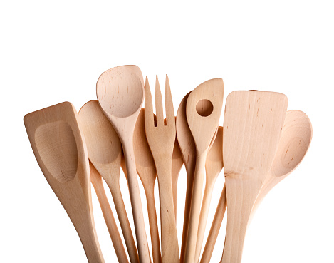 Assorted different kitchen wooden utensils cutlery on white