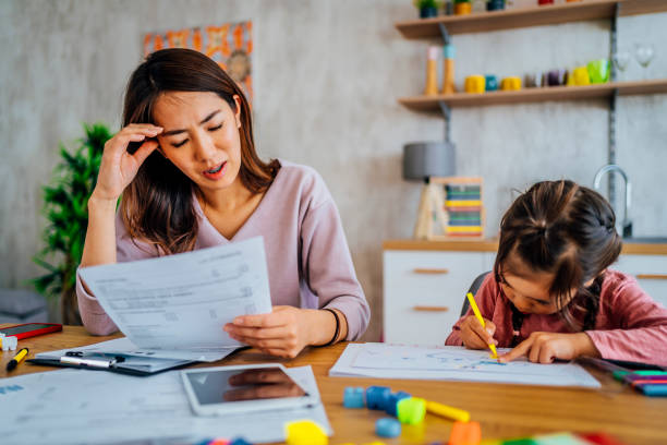 istock Worried mother going through her financials 1403495828