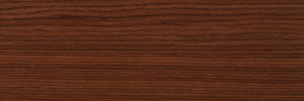 istock Awesome dark brown nut veneer background. Natural wood texture. 1403497355
