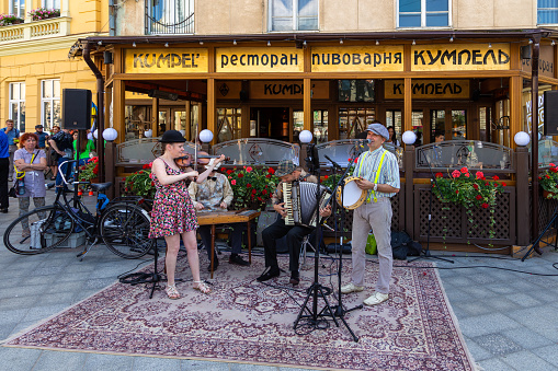 Lviv, Ukraine - 09 June 2018: Traditional buildings in a cobblestone street in historical Old town of Lviv.