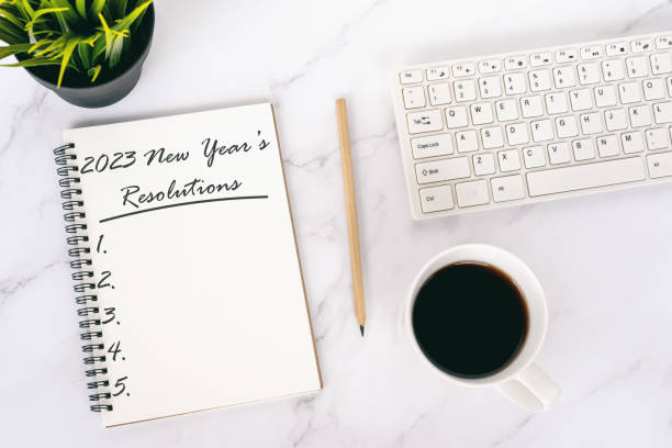 New Year's Resolutions 2023 text on note pad flat lay stock photo