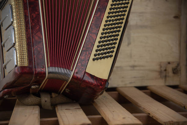 old red accordion Old red accordion. Wind musical instrument. Old concertina. Musical orchestra instrument. Equipment that reproduces musical sounds. accordion instrument stock pictures, royalty-free photos & images