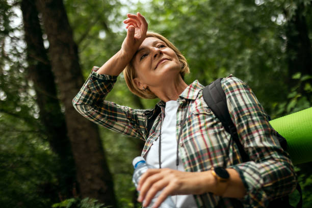 istock Hiker female in wood area hydrating taking a break 1403502564