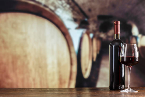 istock Wine cellar with wine bottle and glasses. Red wine tasting in the wine cellar. 1403502810