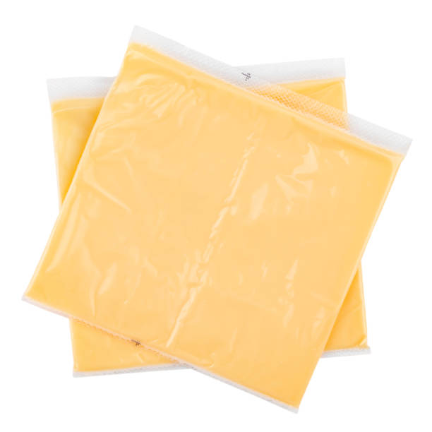 istock Processed cheese for making hamburgers and cheeseburgers wrapped in clear transparency plastic package isolated on white background. 1403502874