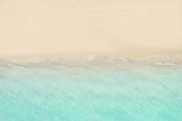 Top view of tropical Seychelles sand beach. Blue, turquoise transparent water surface of ocean, sea, lagoon. Horizontal background. Aerial, drone view stock photo